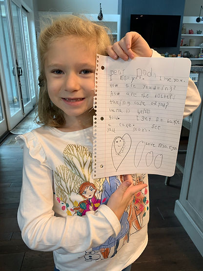 Pete's daughter holds up a letter that she wrote to her dad with encouraging words.