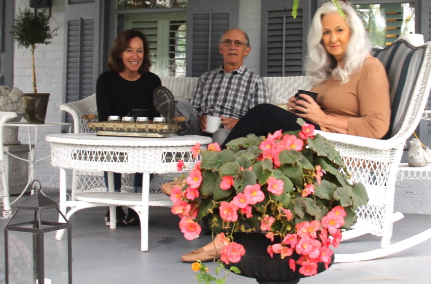 Marianne and Thom Barry visit with Donna Tinberg on their front porch set back from High St.