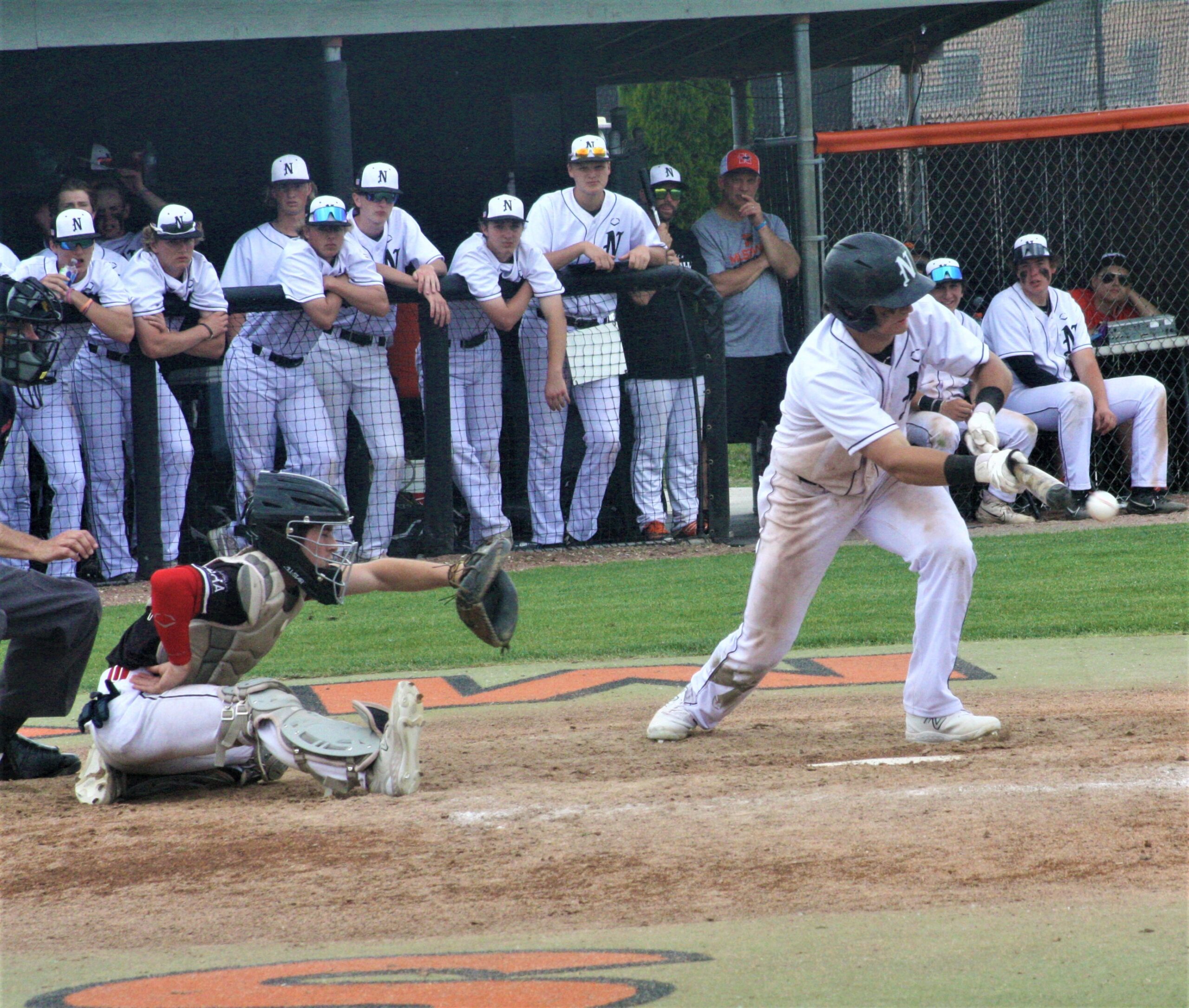 Northville third baseman Luke Dieringer drops down a perfect sacrifice bunt.
