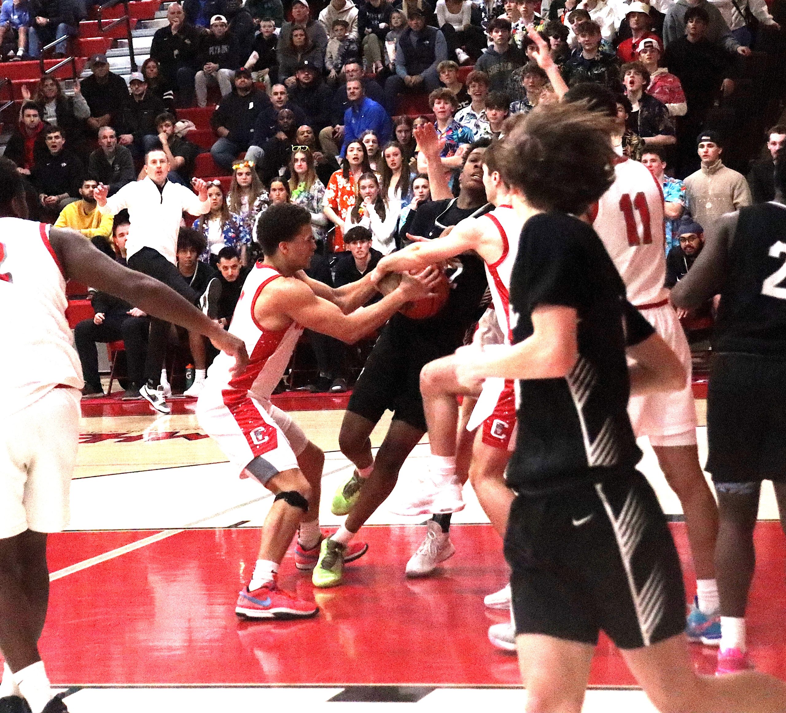 Dist4 - Social House News Caleb Williams attempts to force a jump ball as Plymouth sophomore Zerry Rue drives to the basket