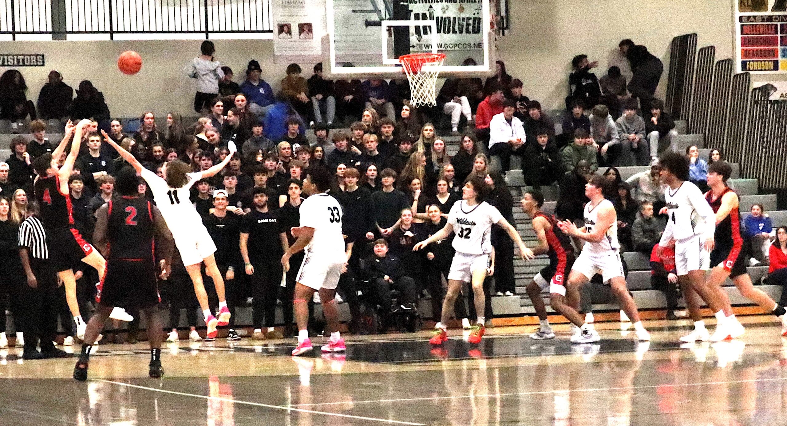 The Canton student cheering section watches intently as Teddy Winstel launches a baseline jumper