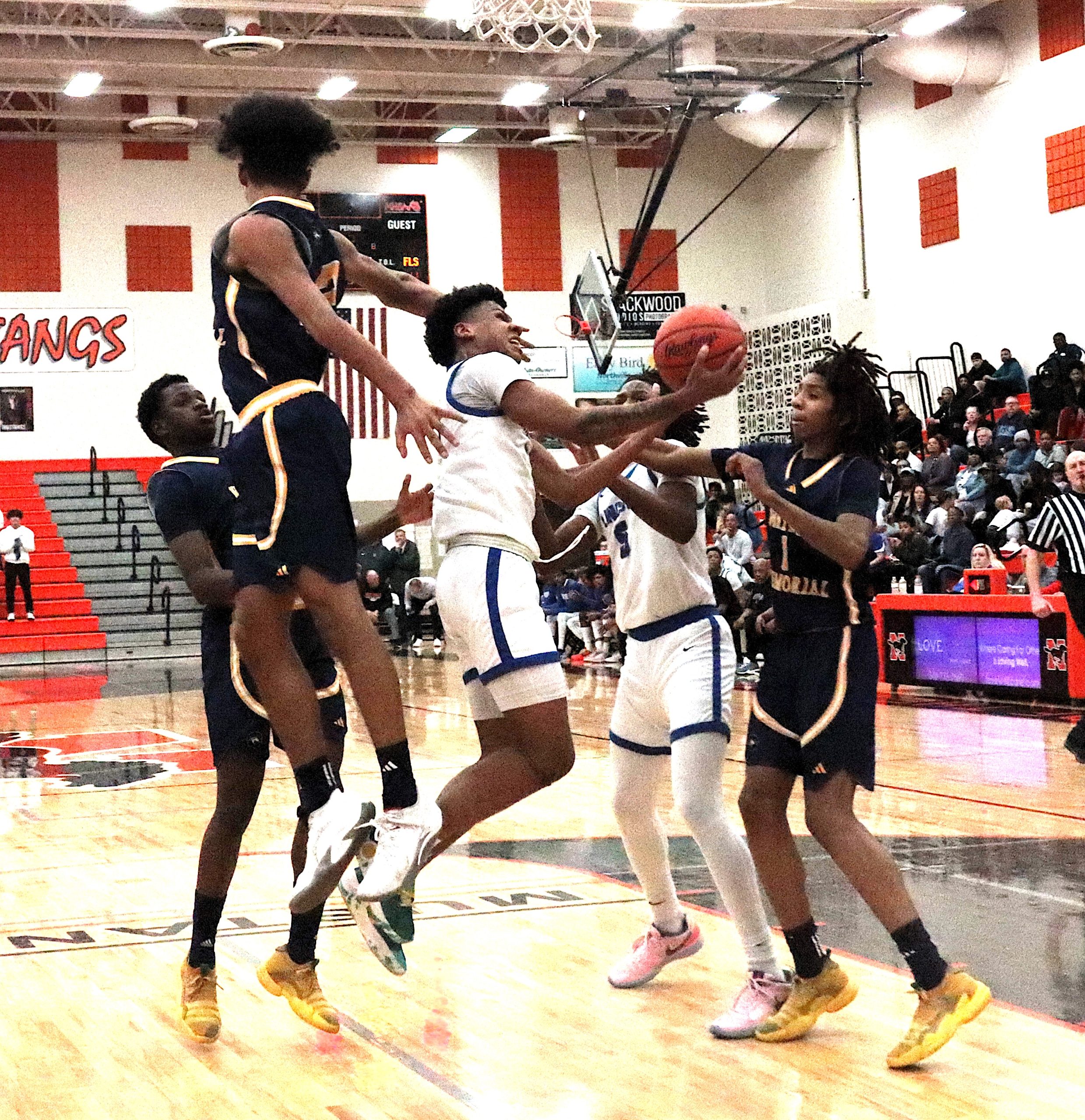 Lincoln guard Dante Wimberly was met by a trio of Zebras when he ventured into the lane Tuesday night.