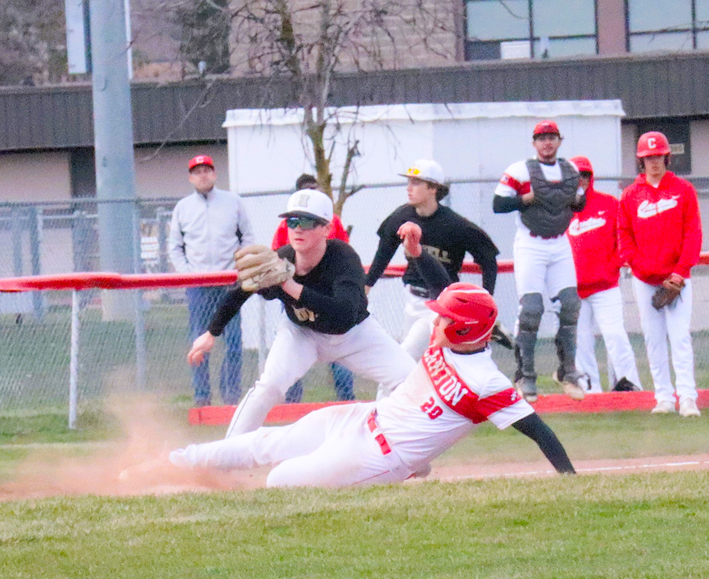 A Canton baserunner slides safely into third