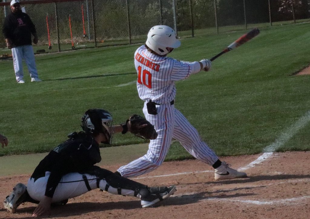 Northville's Luke Dieringer rips a single during the third inning of Monday's game against Howell.