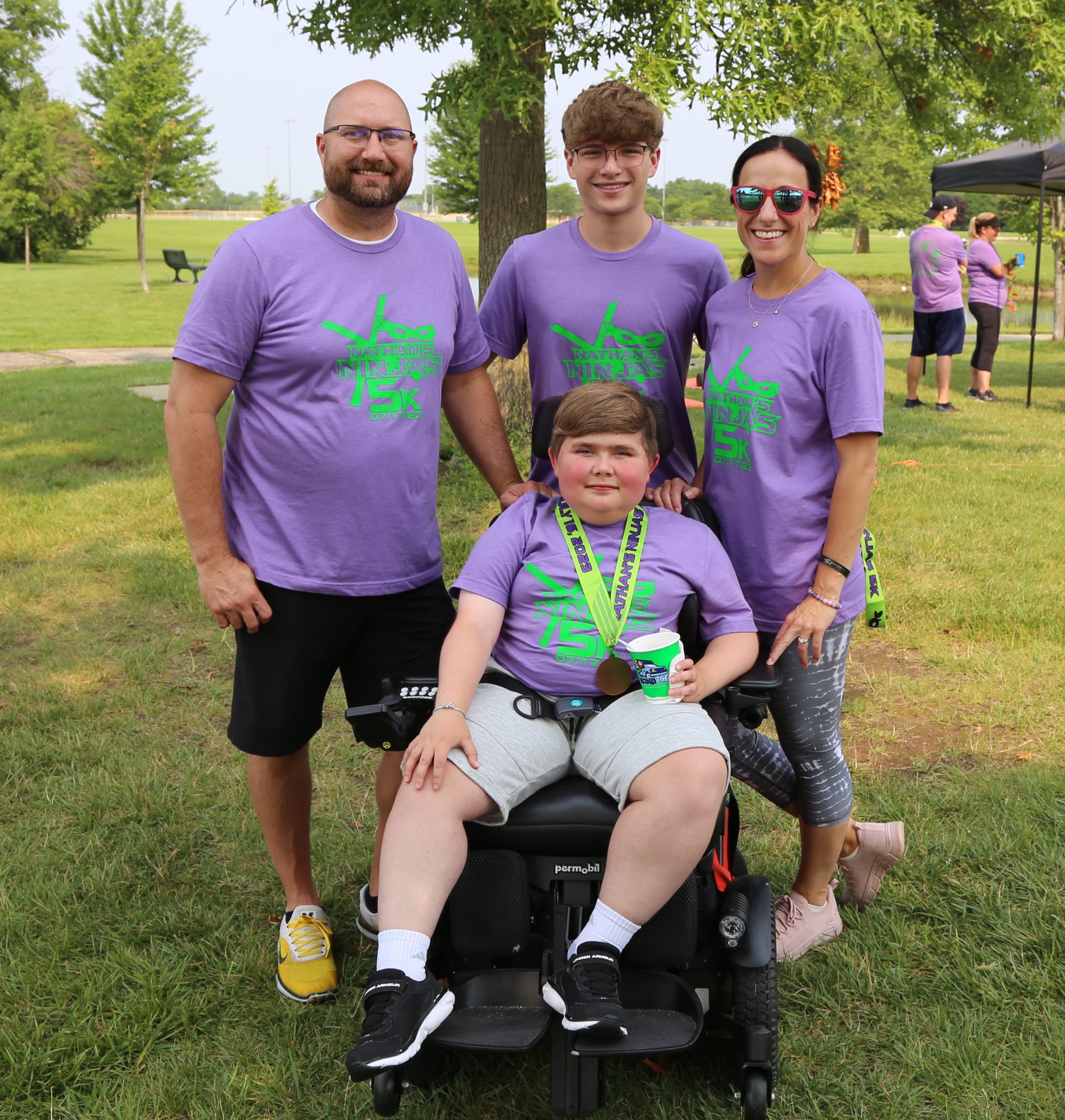 Nathan Miller is pictured with his parents Ryan and Andrea and his older brother Nick.