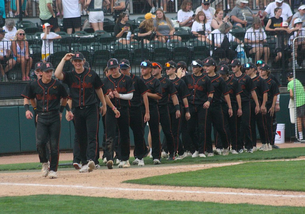 Northville baseball players walk off the McLane Baseball Stadium at Kobs Field turf after defeating Bay City Western, 9-2.