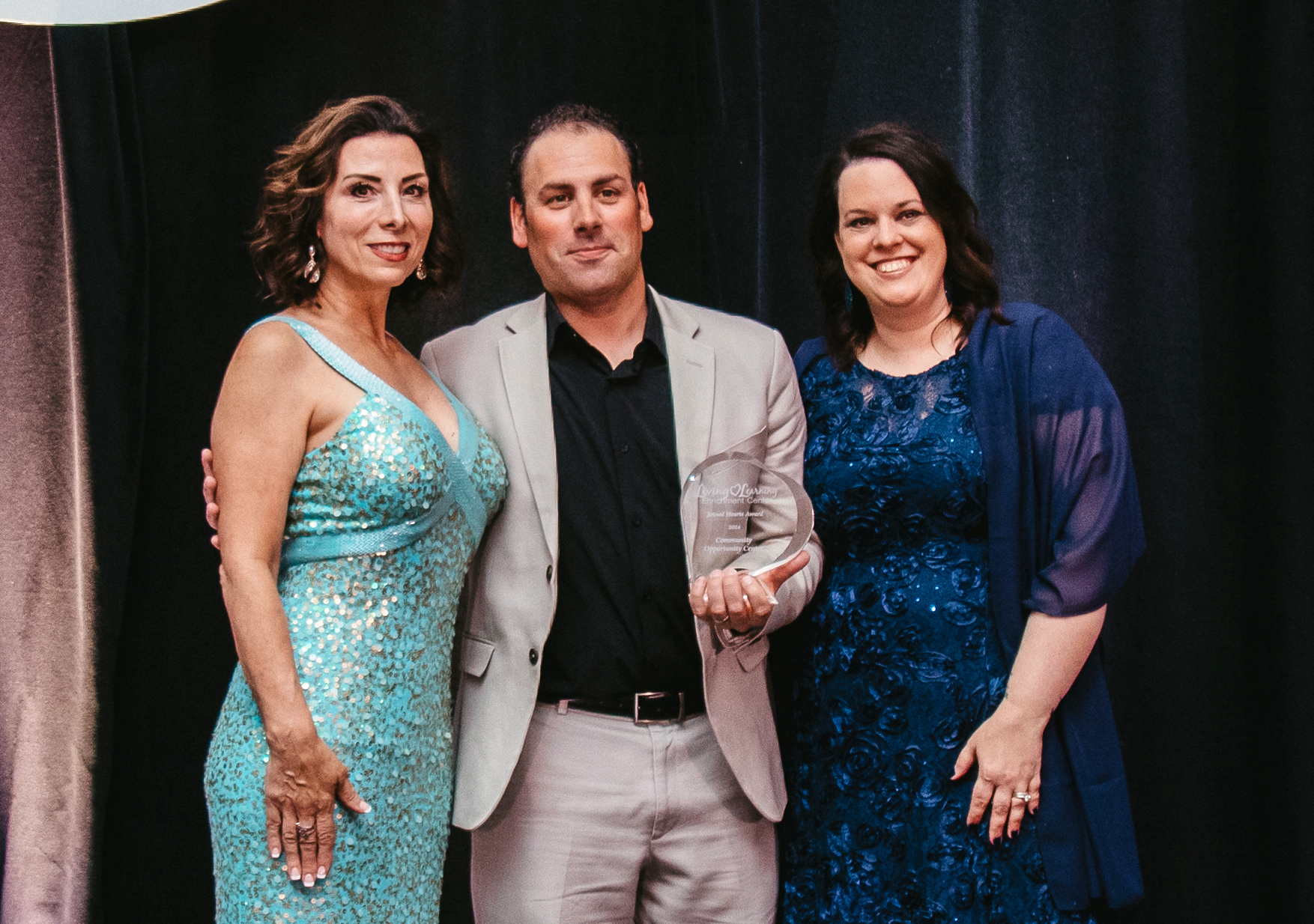 HopesDreams5 - Social House News Community Opportunity Center (C.O.C.), based in Livonia, received this year’s Joined Hearts Award. Pictured (left to right): Rachelle Vartanian, Michael Mies of Community Opportunity Center, Pamela Travis PHOTO BY KIMBERLEY SOLAK PHOTOGRAPHY