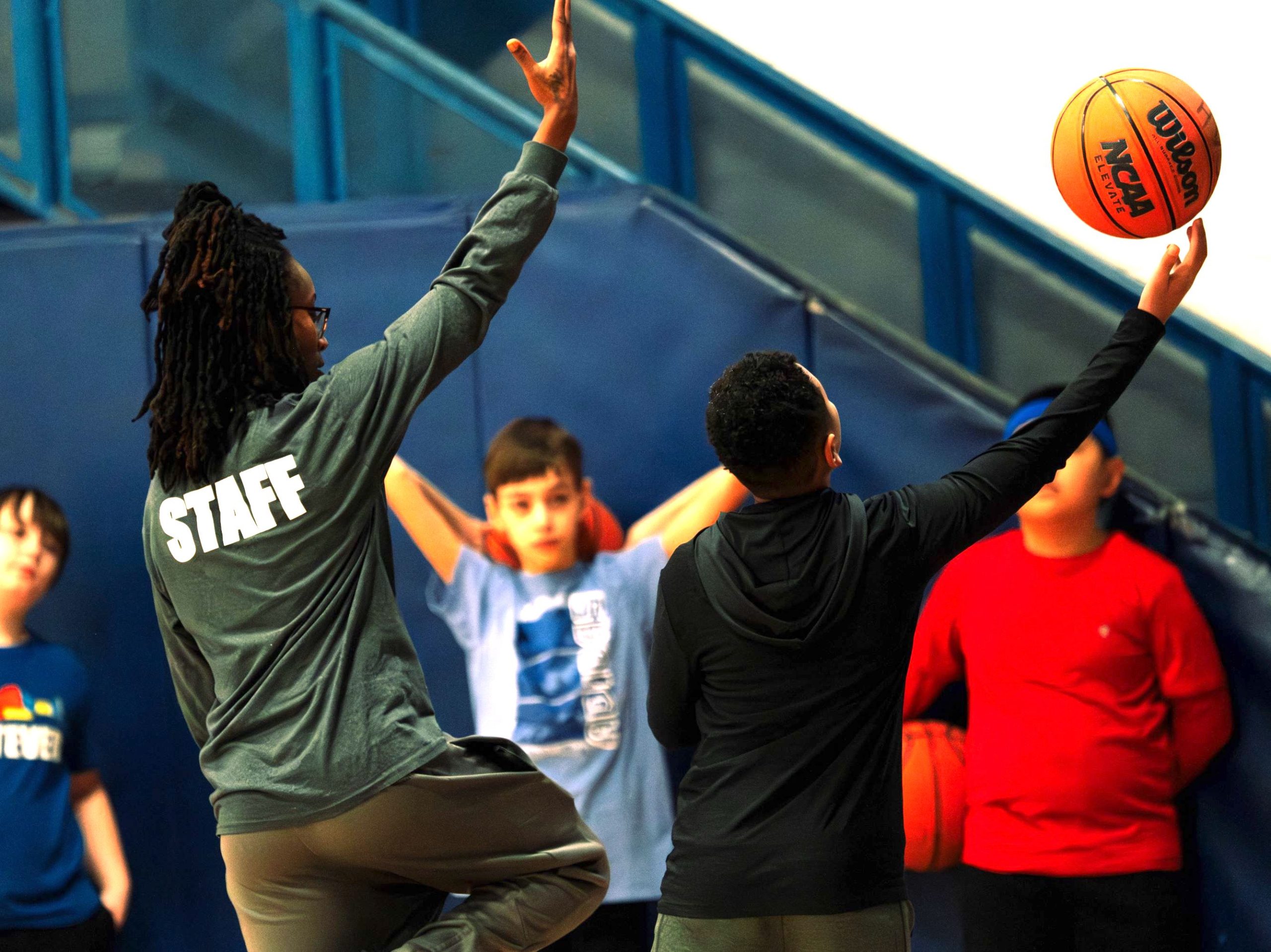 ballerspic - Social House News An HVS staff member helps a Ballers camp attendee perfect a right-handed layup