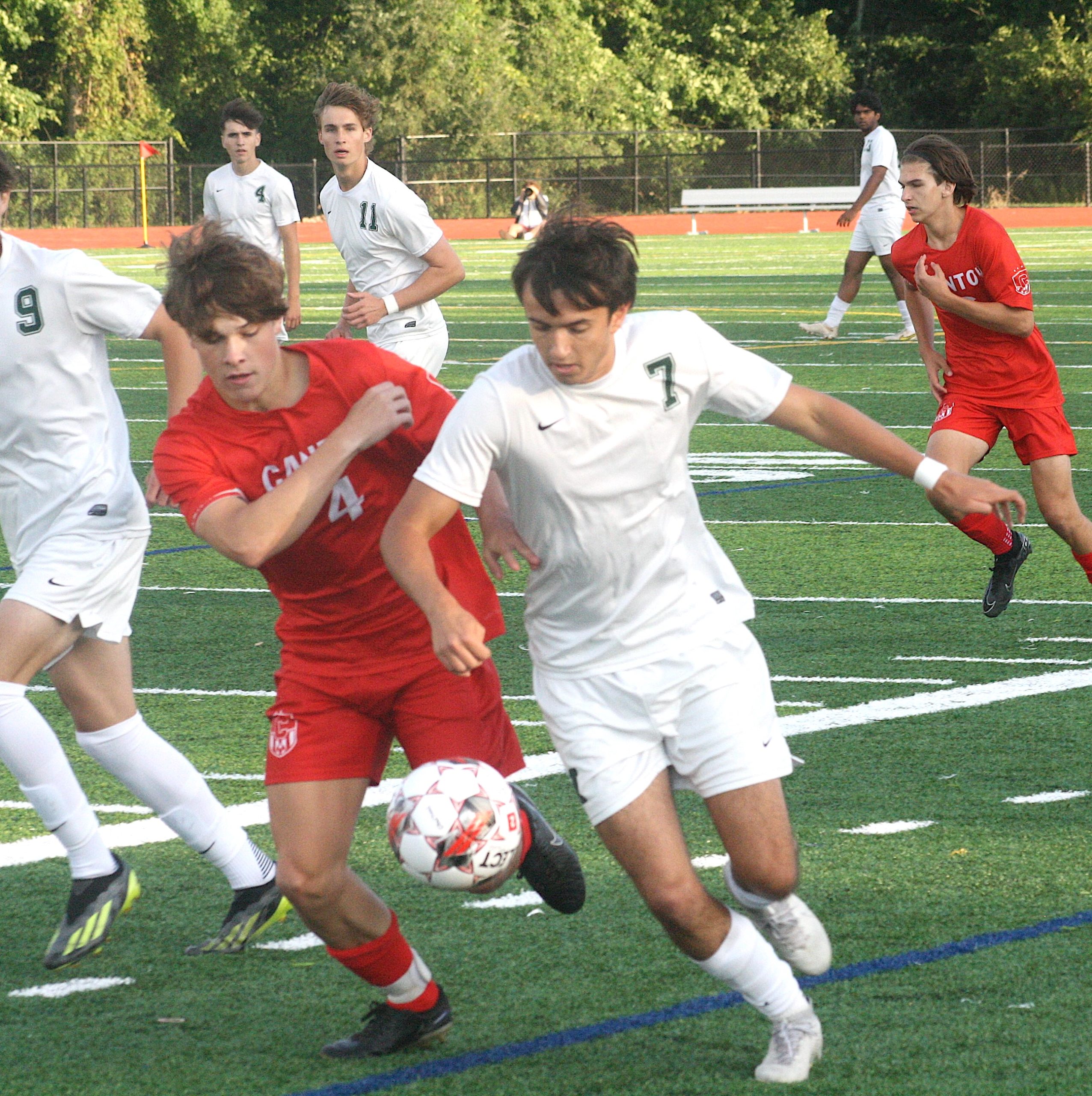 CntSocc2 - Social House News A Canton defender cuts the angle of Novi junior Jackson Brickey