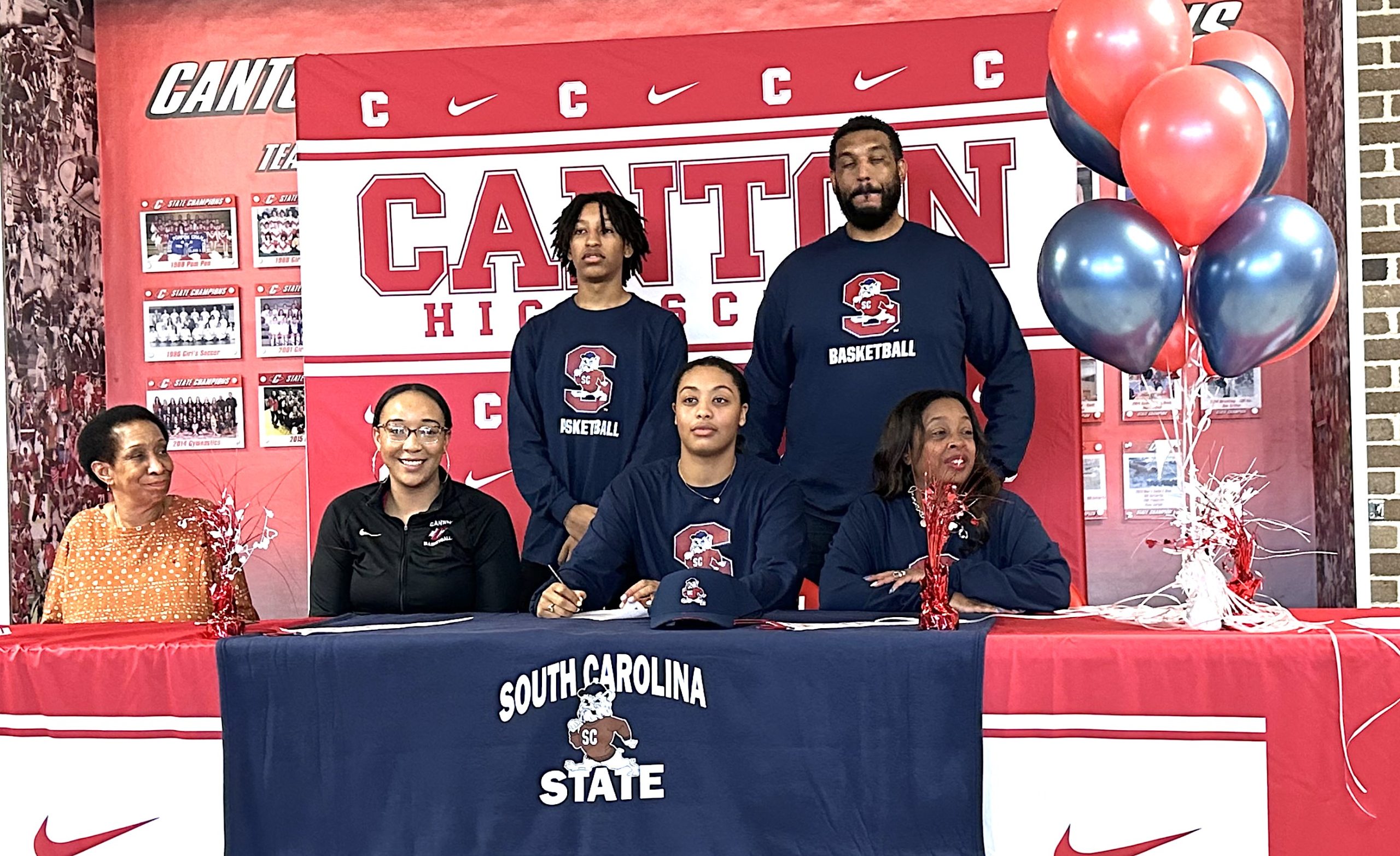 Justice Tramble is pictured with her family and Canton Head Coach Kayla Bridges during a signing ceremony in January of 2024.