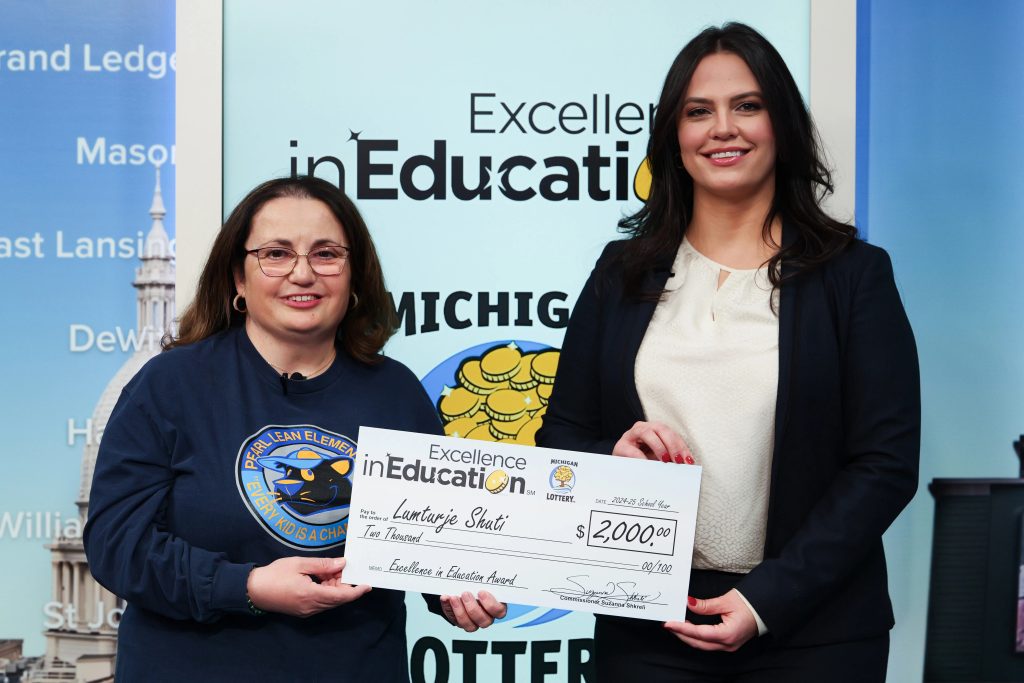 Lottery Commissioner, Suzanna Shkreli (right), presents Lumturje Shuti with her Excellence in Education check.