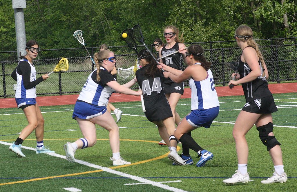 Plymouth's Avery Lombardi works her way through traffic in front of the net Monday night.