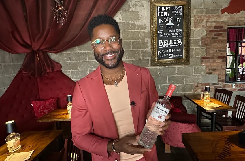 Former Detroit Lion wide receiver Nate Burleson holds a bottle of Valentine LionBlood Orange Vodka during a launch party at Belle's Lounge in Ferndale.