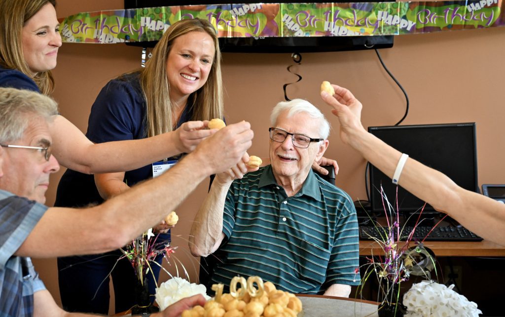 Paul Ivan, a 100-year-old TAVR recipient at Corewell Health East Troy, celebrates his recent 100th birthday with his family, doctor and nurses at the hospital on Thursday, July 10, 2025.