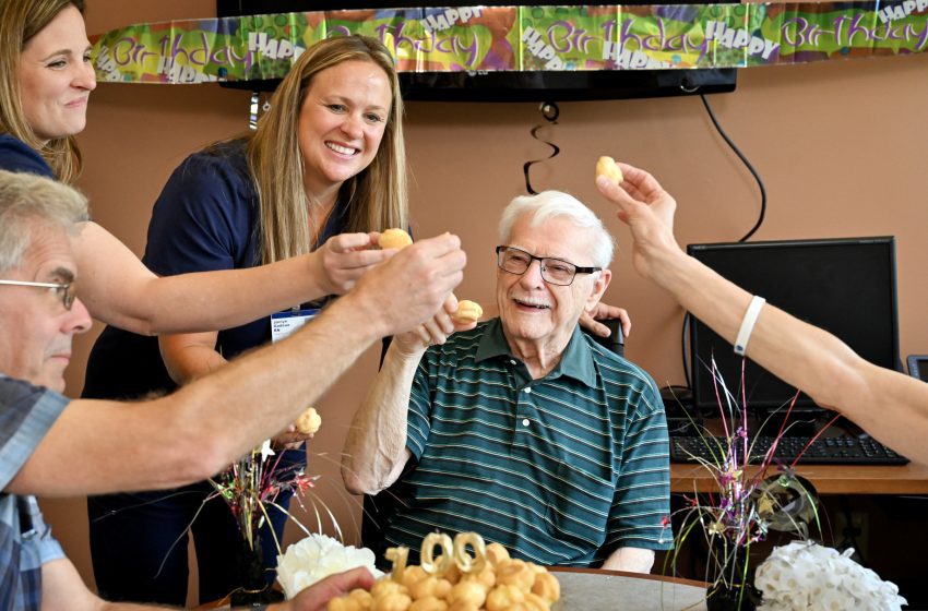 Paul Ivan, a 100-year-old TAVR recipient at Corewell Health East Troy, celebrates his recent 100th birthday with his family, doctor and nurses at the hospital on Thursday, July 10, 2025.