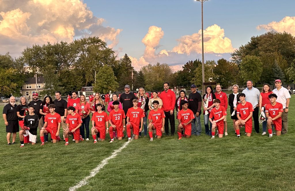 Canton senior soccer players pose with their parents prior to Thursday night's 6-0 victory over Walled Lake Central.