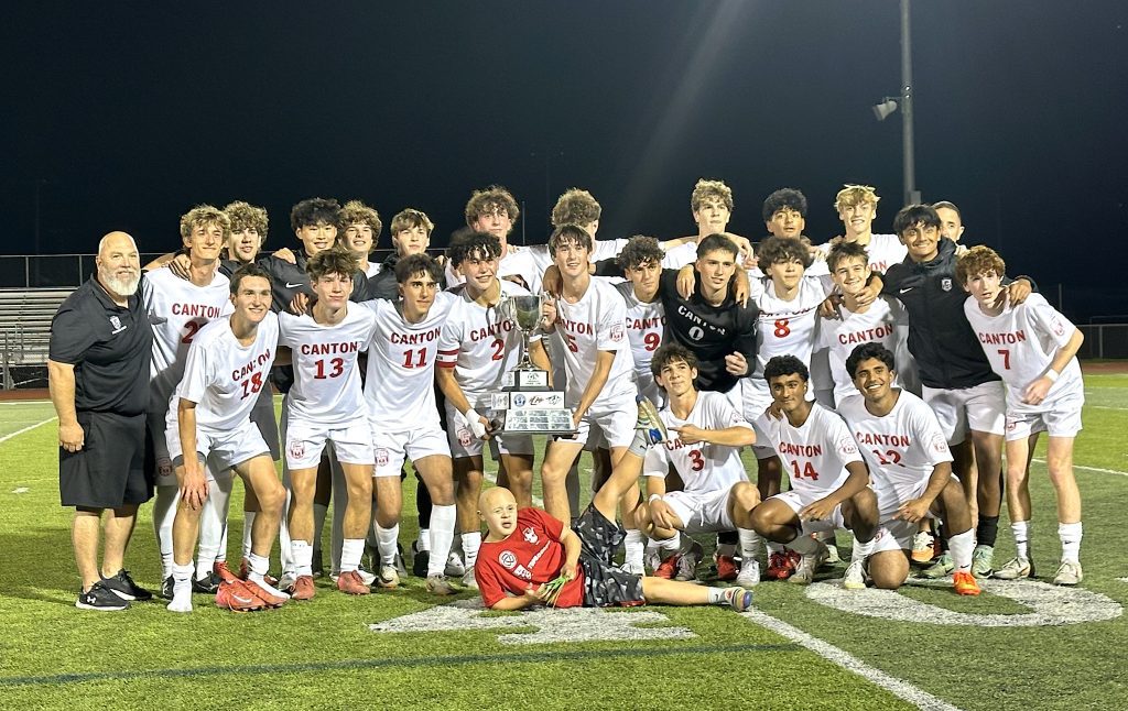 Members of Canton's boys soccer program pose with the P-CEP championship trophy they won Thursday with a 2-1 victory over Salem.