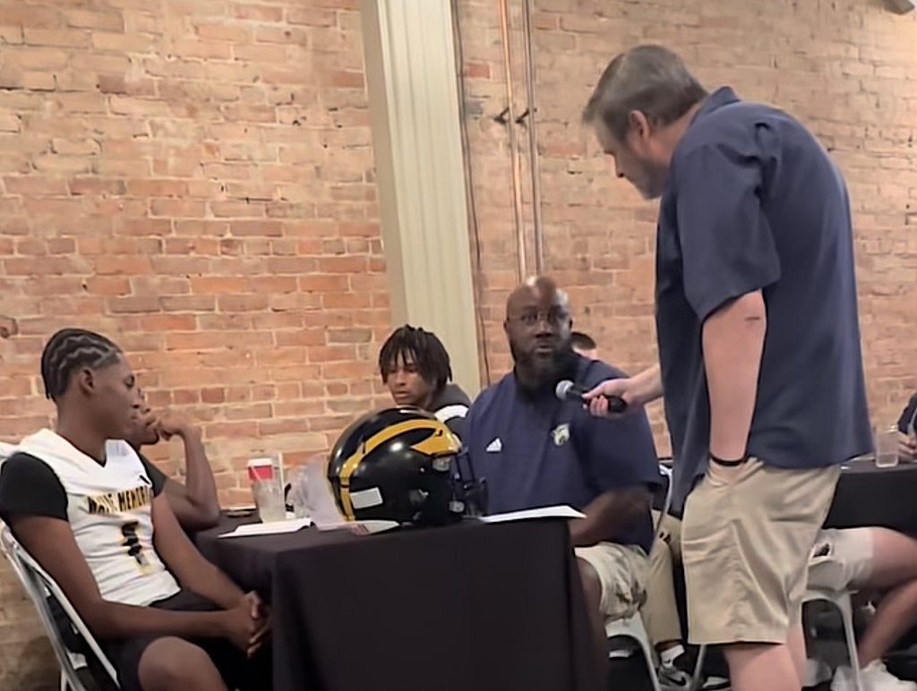 Wayne Memorial Head Football Coach Eric Pettway is interviewed by Sean Baligian during the 2025 KLAA Football Media Day at Genitti's Hole In the Wall in Northville.