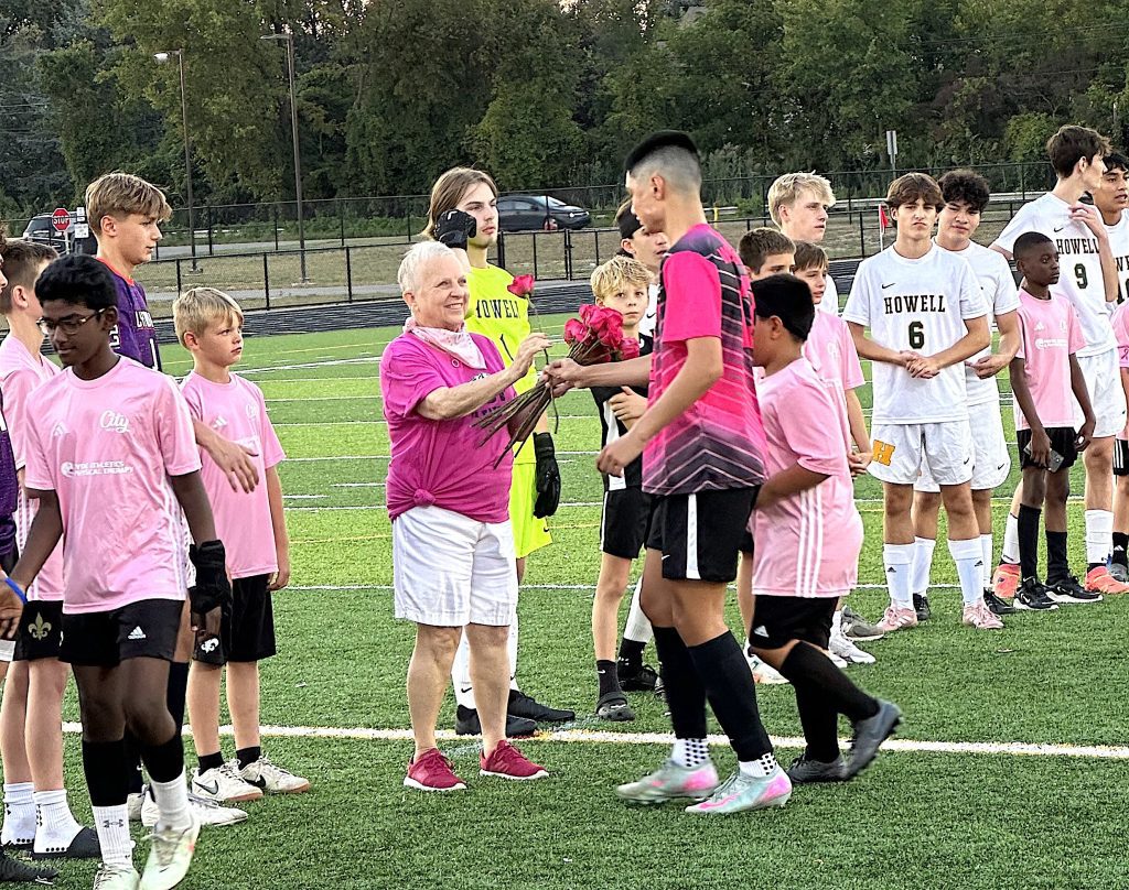 Cancer survivor/Pink Out honoree Mary Meier received a rose from each Wildcat player during a pre-game ceremony.