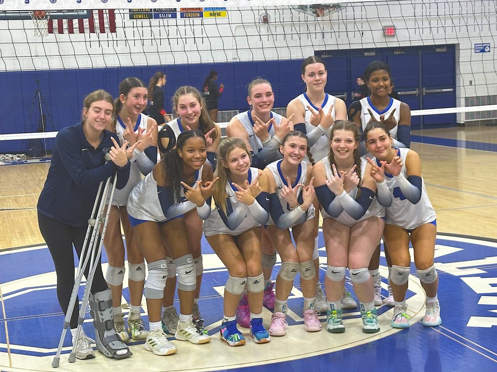 Salem's volleyball team poses for a photo after its four-set triumph over Canton.