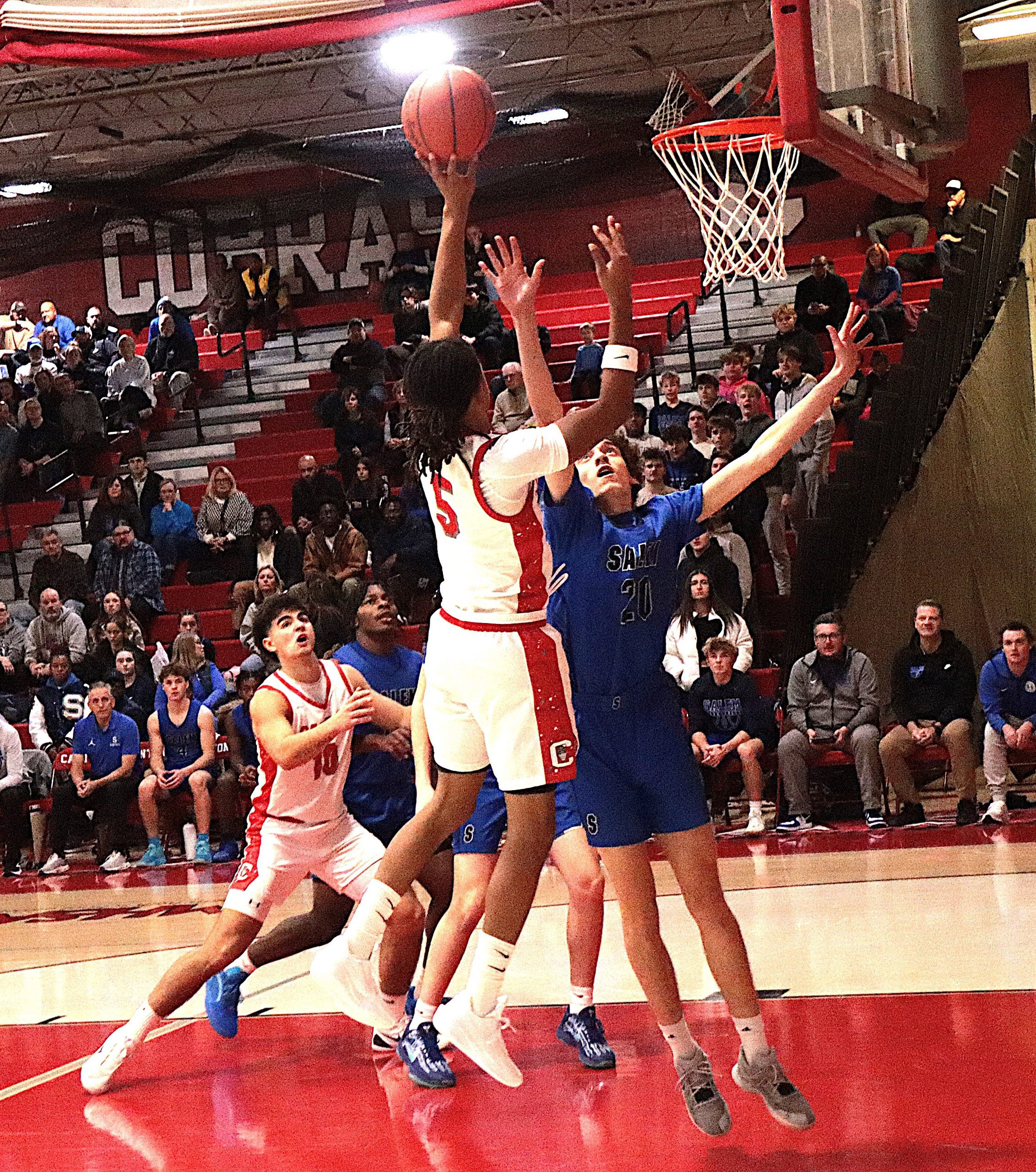 Canton senior guard Jaylen Tramble releases a soft floater over a Salem defender