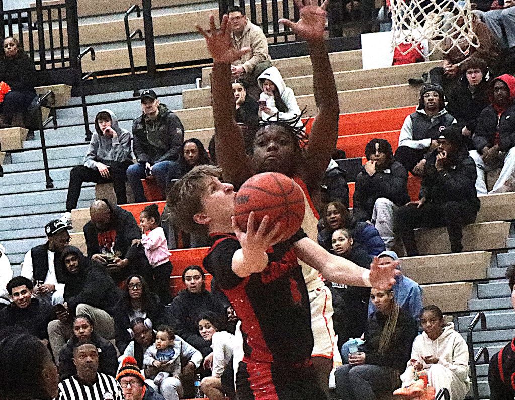 Canton's Noah Tarquinto takes the ball to the basket against Belleville's Adam Coates.