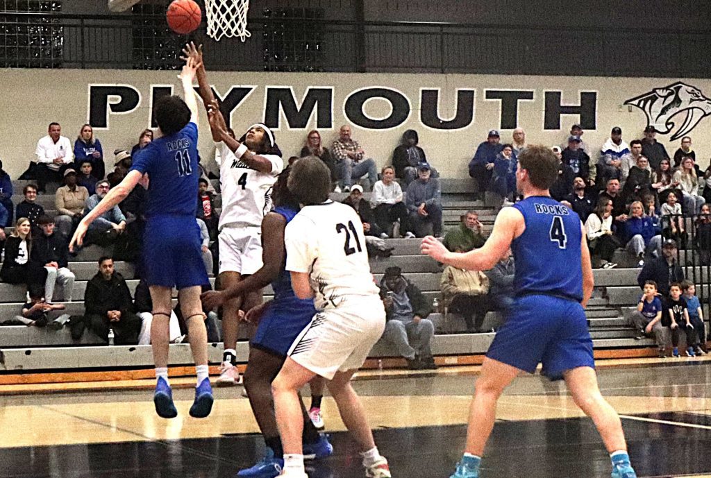 Plymouth's Isaiah Hooks releases a contested shot near the rim during the first half Friday night.