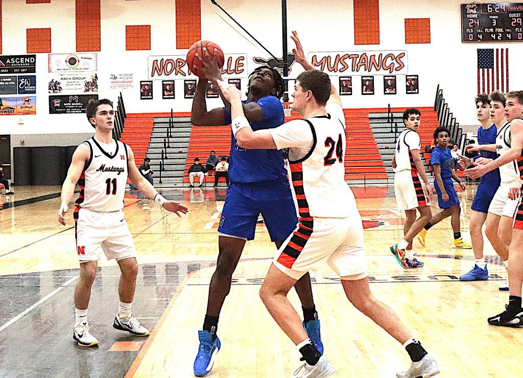 Salem senior Nye Turner works in the paint against Northville's Brody Grezak.
