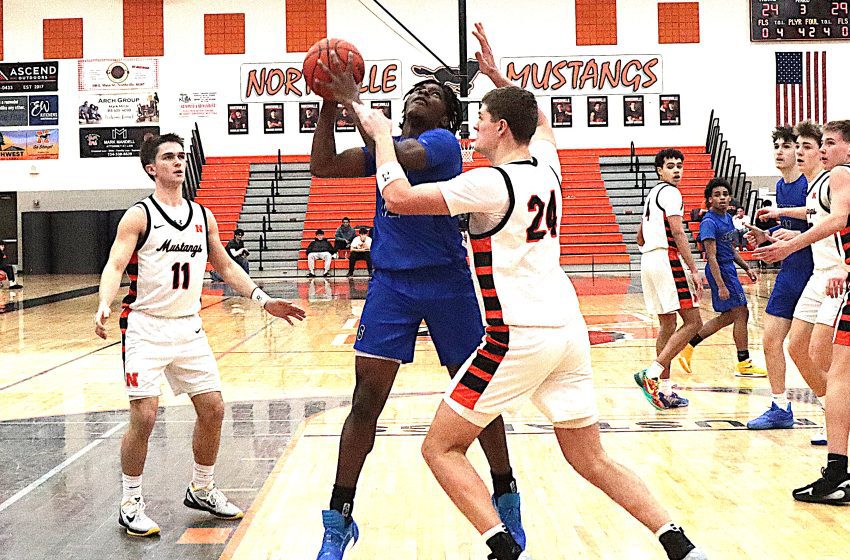 Salem senior Nye Turner works in the paint against Northville's Brody Grezak.