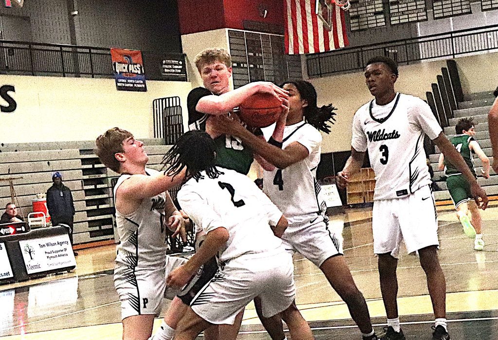 Plymouth players swarm Novi's Greyson Fielder to force a jump ball early in Wednesday's game.