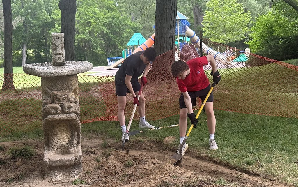 Luke Weidel (left), pictured with his Detroit Catholic Central classmate Sean Goff, work on restoring the iconic Rockwell Sculptures Sandboxes at Plymouth Township Park.