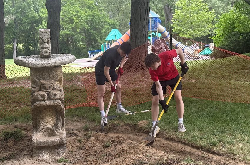 Luke Weidel (left), pictured with his Detroit Catholic Central classmate Sean Goff, work on restoring the iconic Rockwell Sculptures Sandboxes at Plymouth Township Park.