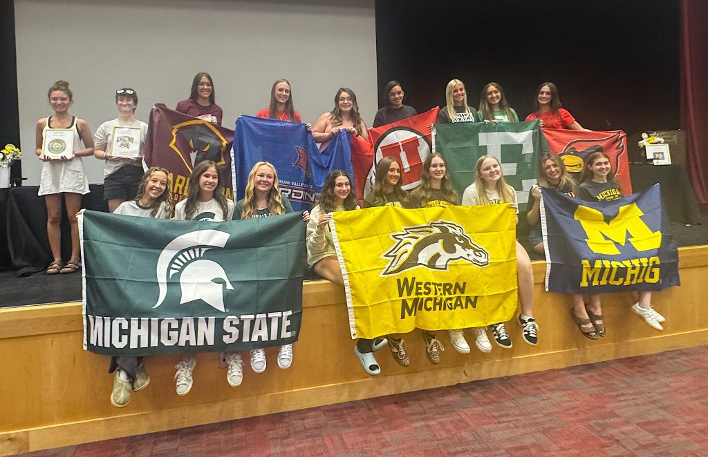 The P-CEP Educational Careers seniors hold flags representing their respective universities.