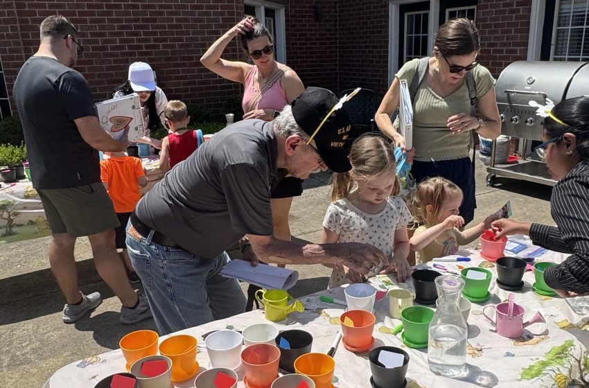 A Waltonwood resident, who is also a Vietnam veteran, helped a camper learn how to plant seeds at one of the seven stations of The Hundred Acre Waltonwood.
