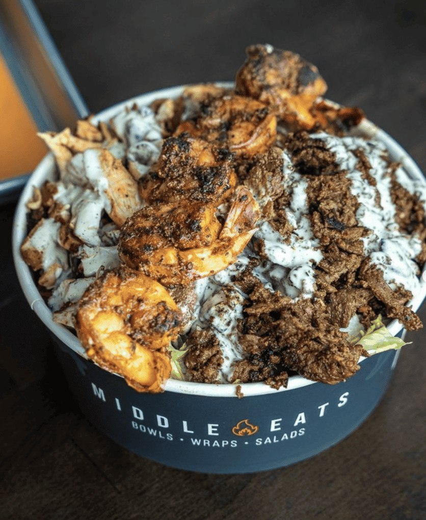 Screen Shot 2026-08-03 at 115147 AM - Social House News Close-up of a loaded Middle Eats bowl with crispy fried chicken, crumbled toppings, and white sauce