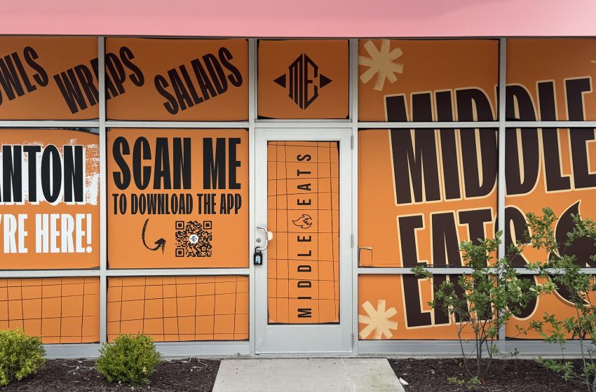 Bright orange storefront panels with bold black text promoting Canton and a QR code for downloading the app.